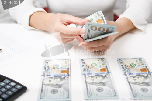 Image of Hands counting money, close up