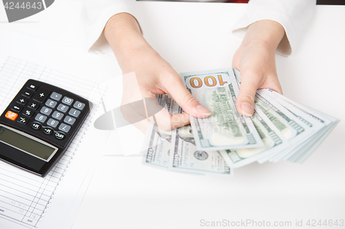 Image of Hands counting money, close up