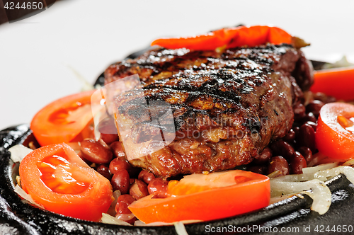 Image of Beef steak with red beans garnish