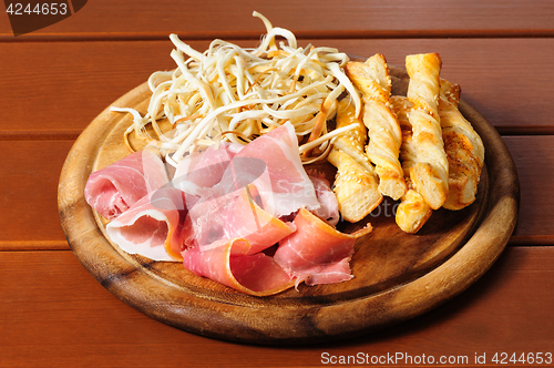 Image of Beer snacks on wooden plate