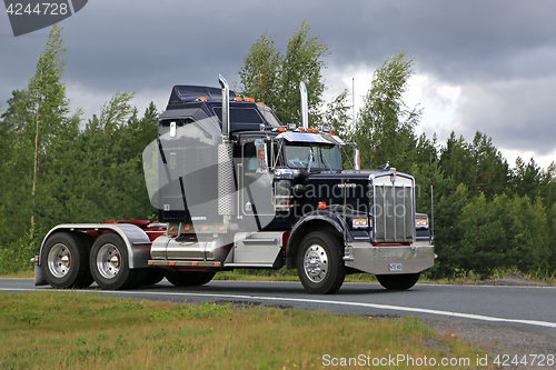 Image of Classic Black Kenworth W900B on a Cloudy Day 