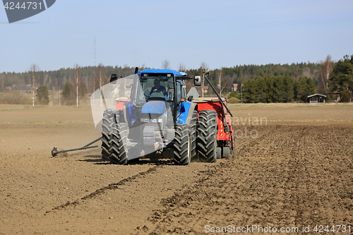 Image of Farm Tractor and Seed Drill on Field