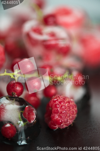 Image of Frozen berries on wooden table