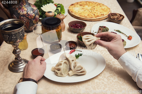 Image of Man eating in georgian restaurant