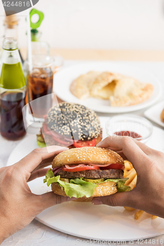 Image of Man eating burgers