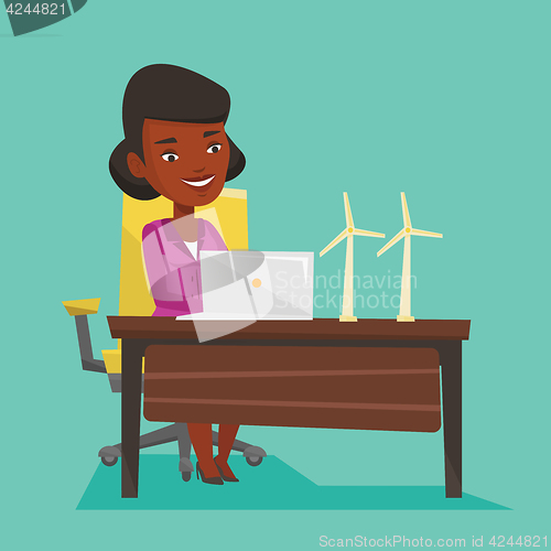 Image of Woman working with model of wind turbines.