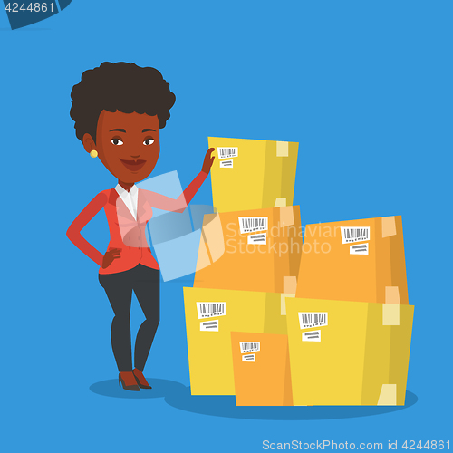 Image of Business woman checking boxes in warehouse.