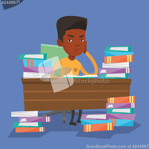 Image of Student sitting at the table with piles of books.