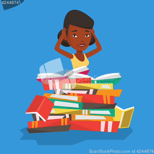 Image of Student sitting in huge pile of books.