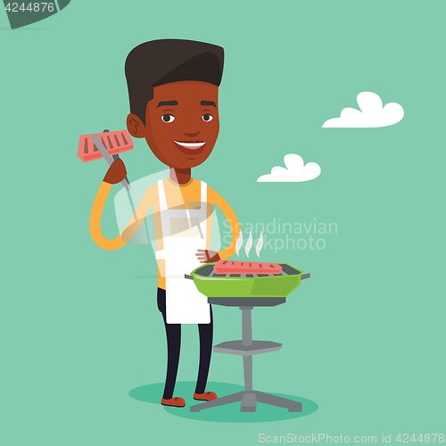 Image of Man cooking steak on barbecue grill.