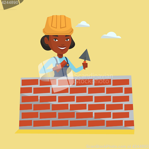 Image of Bricklayer working with spatula and brick.