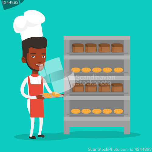 Image of Happy young male baker holding tray of bread.