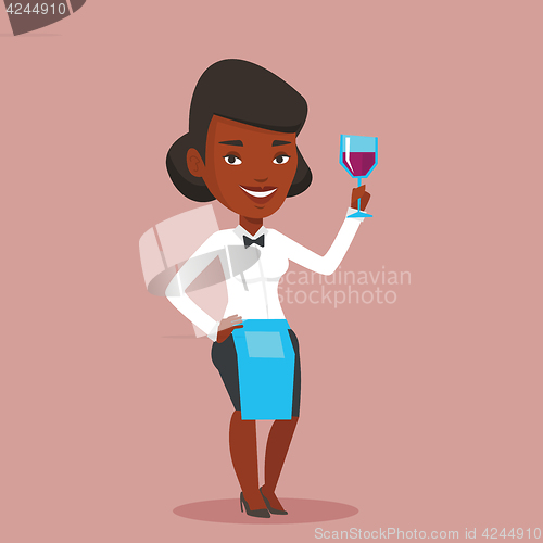 Image of Bartender holding a glass of wine in hand.