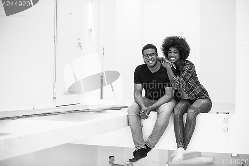 Image of couple having break during moving to new house