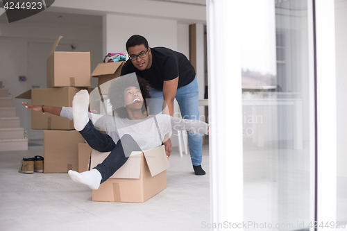 Image of African American couple  playing with packing material