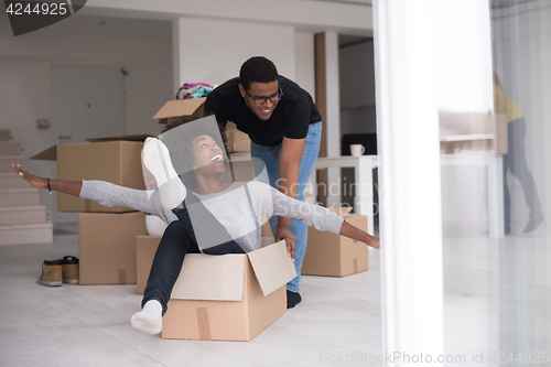 Image of African American couple  playing with packing material