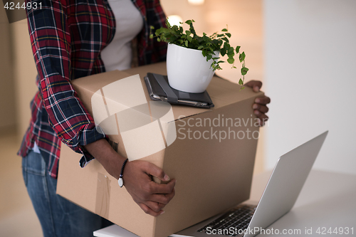 Image of Black girl moving in the new apartment