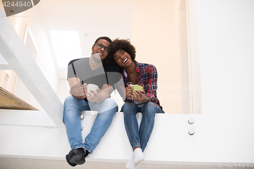 Image of couple having break during moving to new house