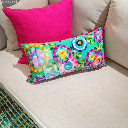 Image of Bright cushions with floral design on a sofa