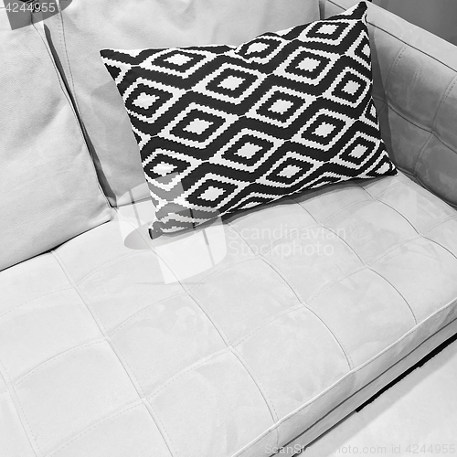 Image of Black and white ornamental cushion on a sofa