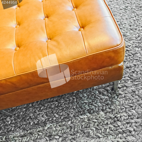 Image of Leather seat on knitted wool carpet