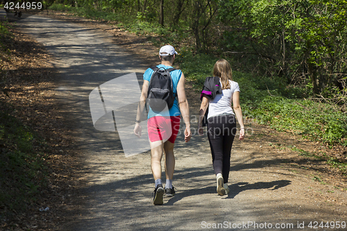 Image of Young woman and a young man walking in the woods