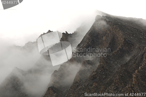 Image of Mountain cliffs in fog