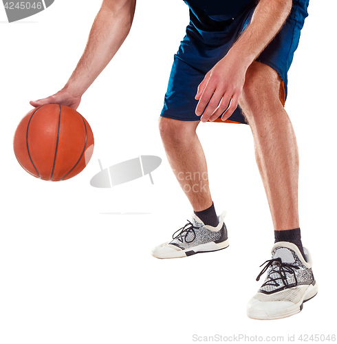 Image of The legs of a basketball player with ball