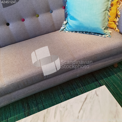 Image of Gray sofa with blue and yellow cushions