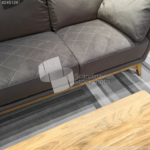 Image of Comfortable gray sofa and wooden coffee table
