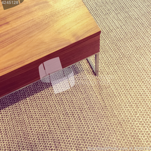 Image of Simple wooden table on carpet floor