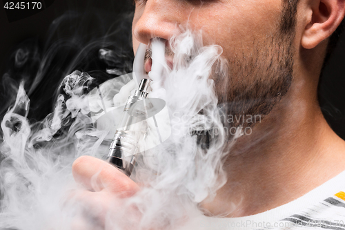 Image of The face of vaping young man