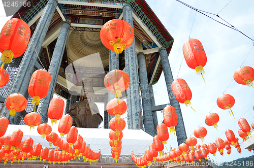 Image of Guanyin and a red lanterns in Chinese Temple Penang, Malaysia