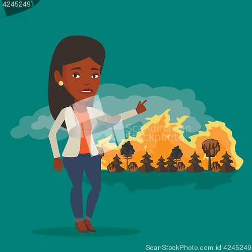 Image of Woman standing on background of wildfire.