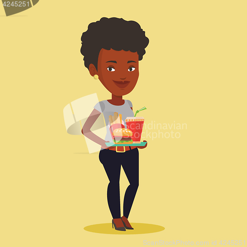 Image of Woman holding tray full of fast food.