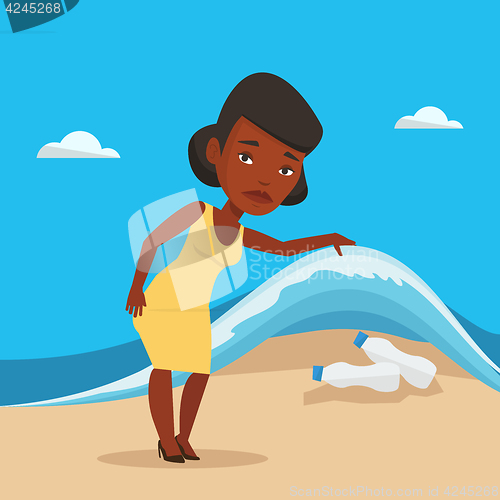 Image of Woman showing plastic bottles under sea wave.