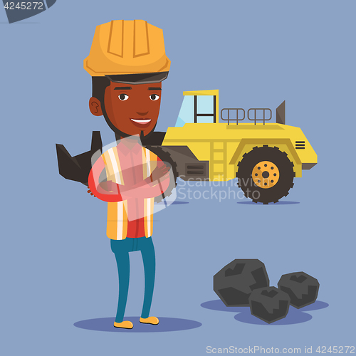 Image of Miner with a big excavator on background.