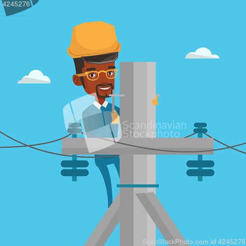 Image of Electrician working on electric power pole.