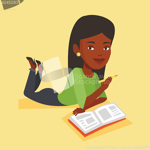 Image of Student laying on the floor and reading book.