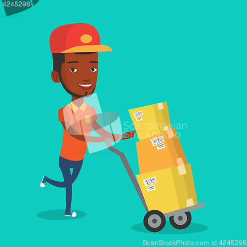 Image of Delivery postman with cardboard boxes on trolley.