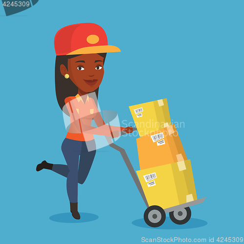 Image of Delivery postman with cardboard boxes on trolley.