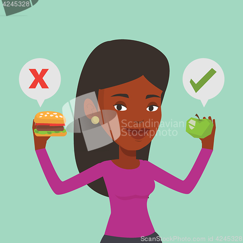 Image of Woman choosing between hamburger and cupcake.