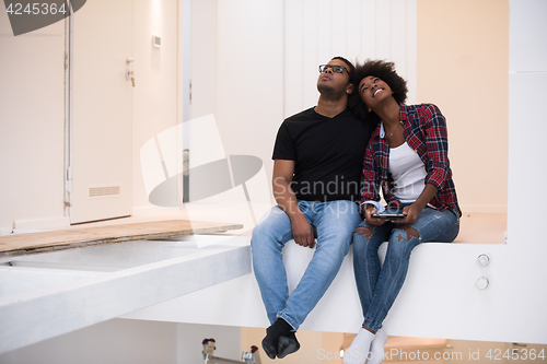 Image of couple having break during moving to new house