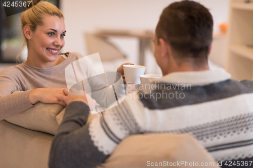 Image of Young couple  in front of fireplace