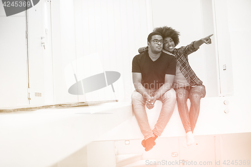 Image of couple having break during moving to new house