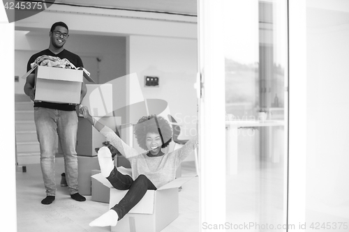 Image of African American couple  playing with packing material