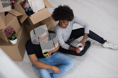 Image of African American couple relaxing in new house