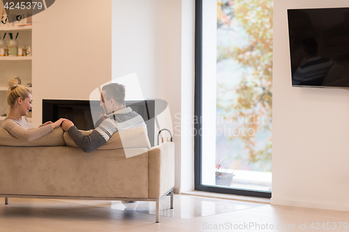 Image of Young couple  in front of fireplace