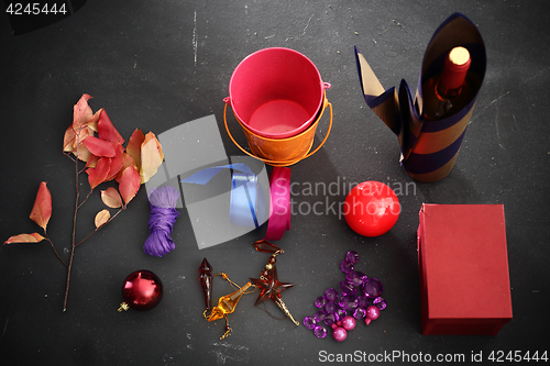 Image of Packaging holiday gifts. Decoration of bottles, packaging bottles of wine How to wrap a gift for Christmas?