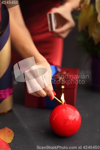 Image of Red candle, festive atmosphere in the house